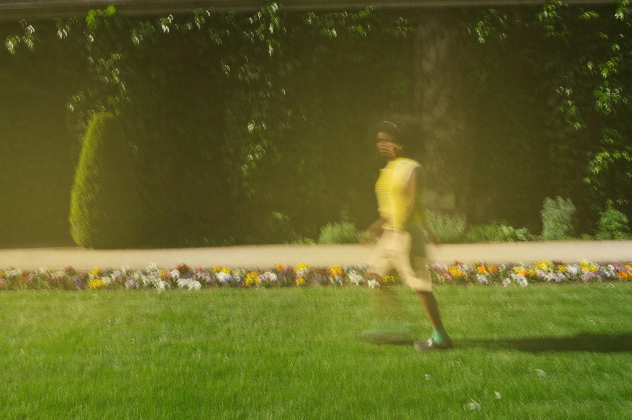 Runner in motion through a garden