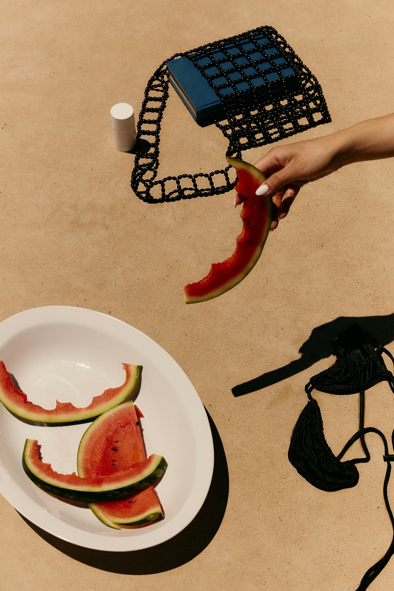 Watermelon slices on white plate, poolside